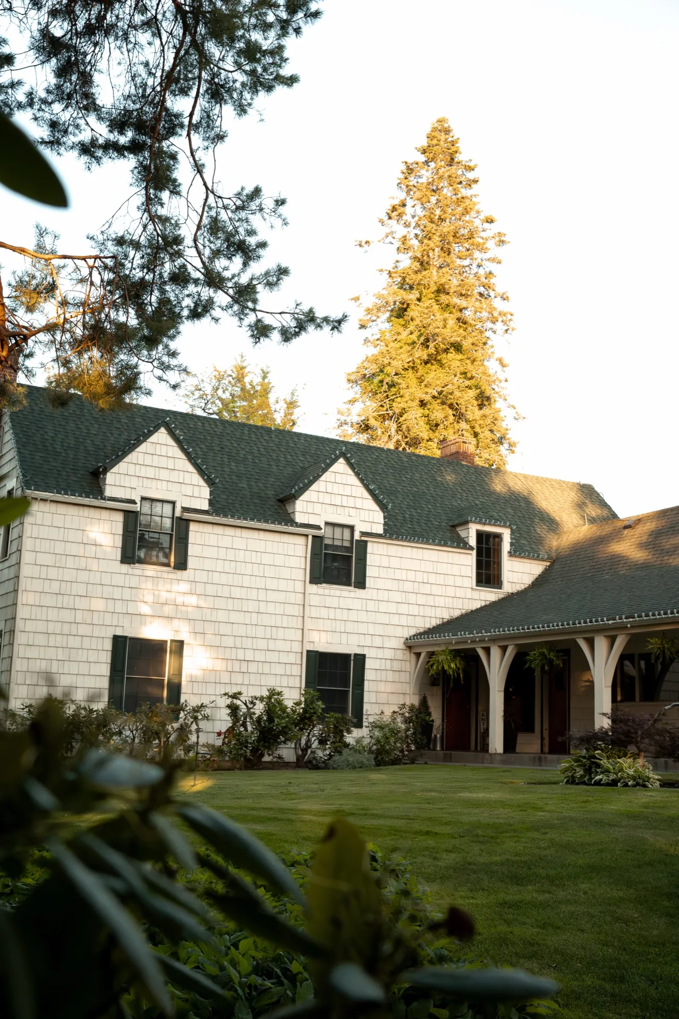 The 1929 house, lawn, and covered porch at last light